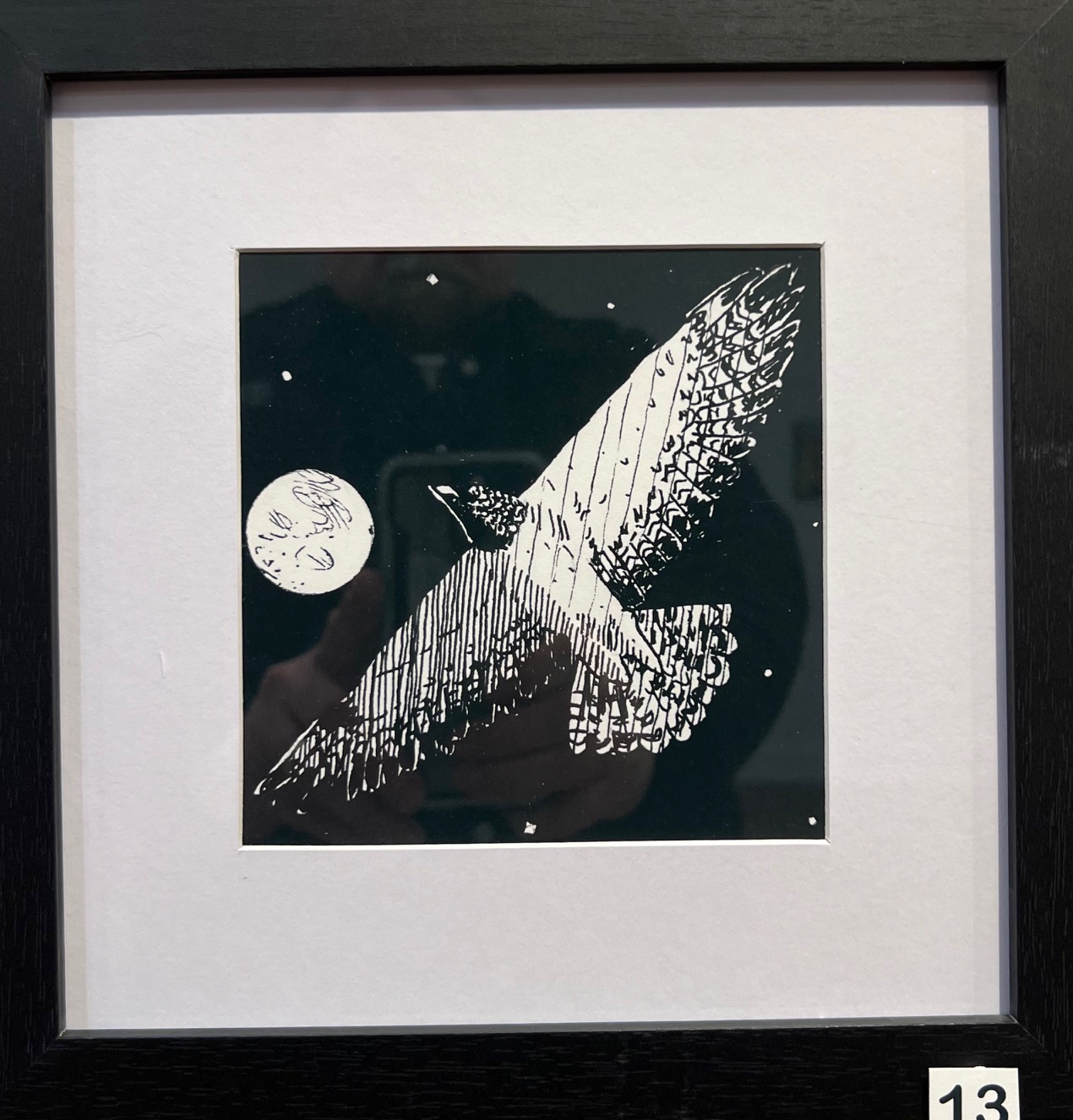 Ink sketch of a bird in flight with the moon and stars in the background