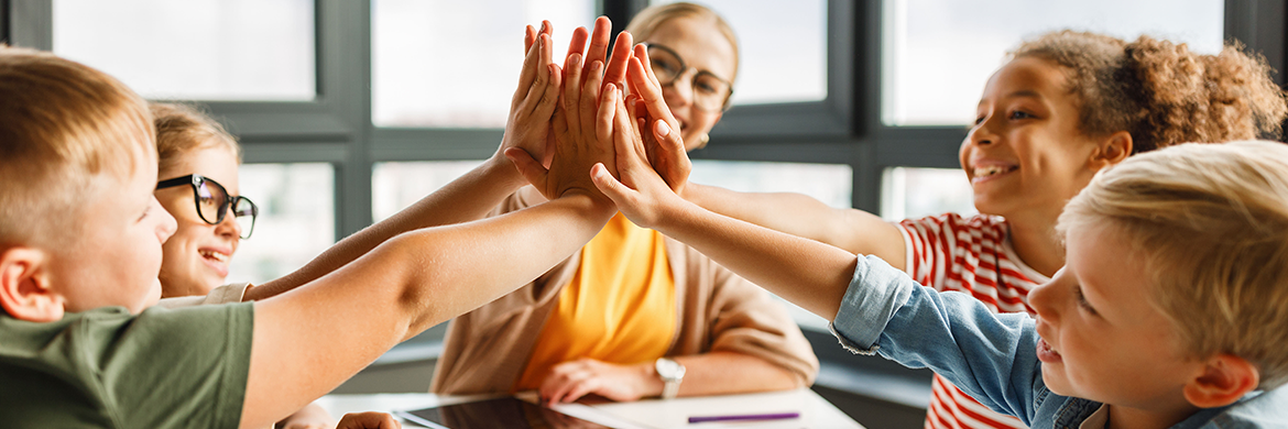 A teacher and her class high-fiving over homework