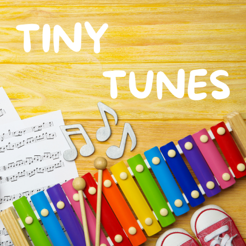 A rainbow xylophone near tiny converse sneakers and a sheet of music.