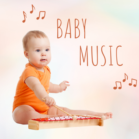 A baby sitting on the ground playing a tiny xylophone.