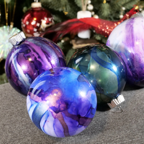 Purple and green alcohol ink ornaments.