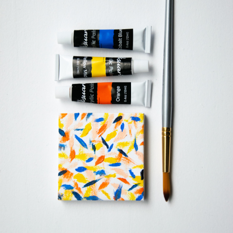 A miniature canvas painted with acrylic paint.