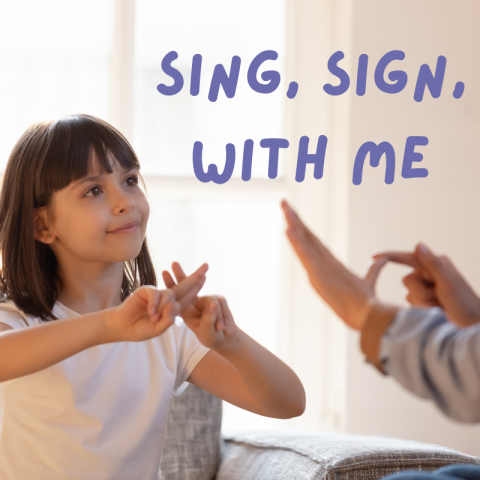 A young girl speaking in sign language with another person.