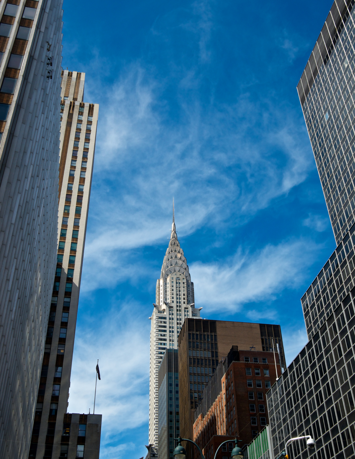 nyc skyline chrysler building in the background blue sky with white wispy clouds