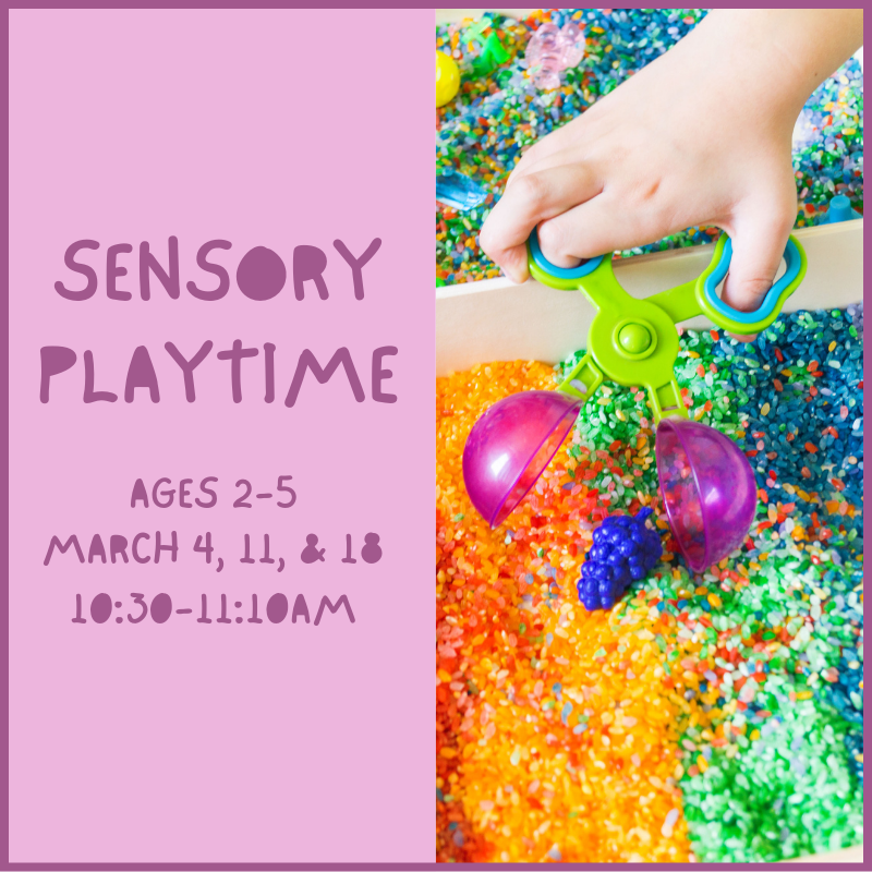 A toddler playing with a sensory activity with colorful rice pieces.