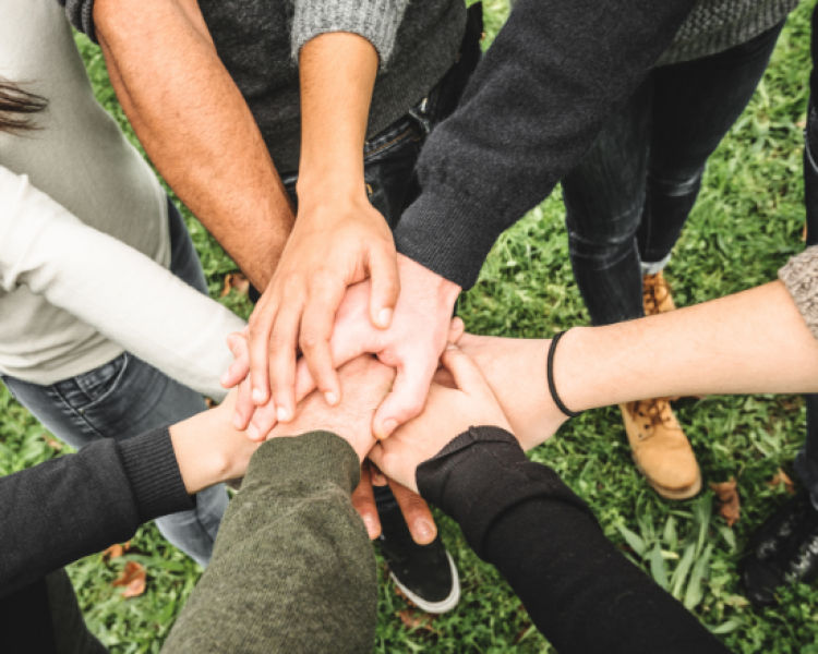 Group of teens stacking their hands