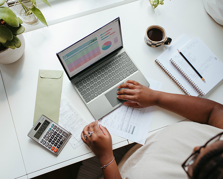 Woman using a laptop with calculator